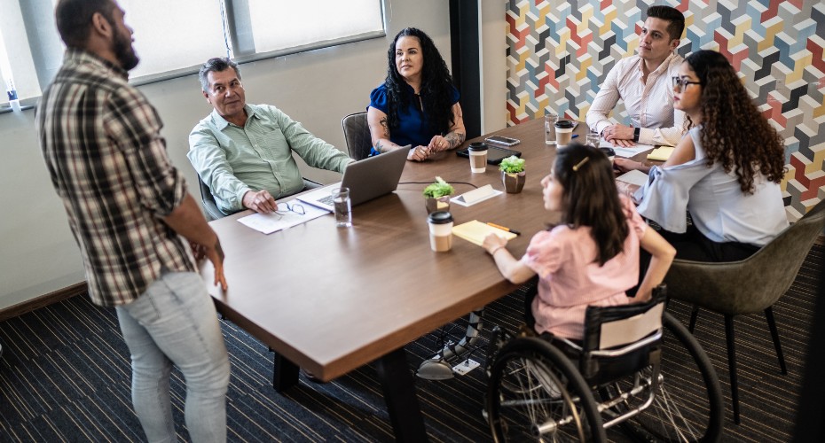 wheelchair user and colleagues around a table